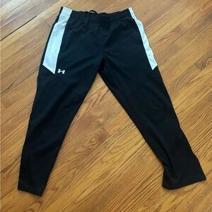 From Under Armour, size medium, black with white strips.